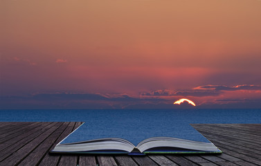 Magical book with contents spilling into landscape background