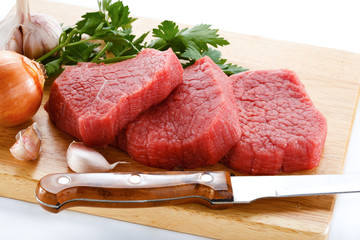 Raw beef on cutting board on white background