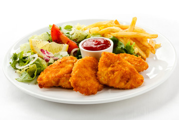 Fried chicken nuggets, French fries and vegetables