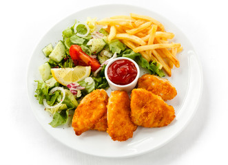 Fried chicken nuggets, French fries and vegetables