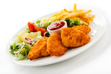 Fried chicken nuggets, French fries and vegetables