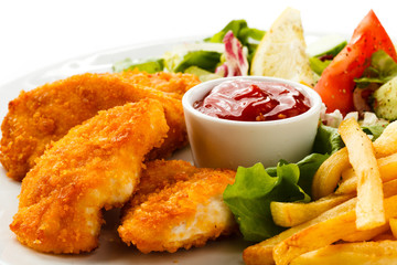 Fried chicken nuggets, French fries and vegetables