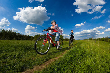 Fototapeta na wymiar Mother and son riding bikes