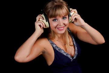 a charming young blonde on a black background with earphones