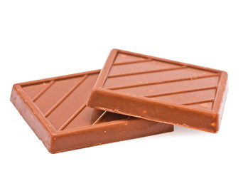 Two tiles of milk chocolate on the white