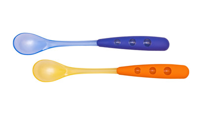 Blue and orange bright children's spoons on the white