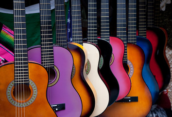 Row of multi-colored Mexican guitars