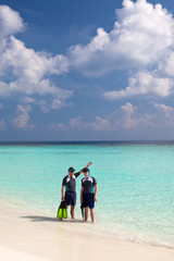 Two men in the sea with the equipment for a snorkeling..