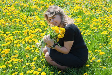 Portrait of a young woman  with a bouquet of dandelions