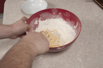 Mixing egg yolk,  sugar and flour  mixture with beaten egg white