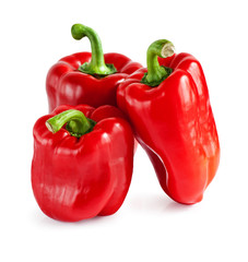 Three red peppers closeup on white background .