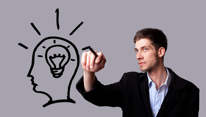 Businessman hand drawing and idea for making money