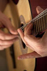 The musician plays a guitar