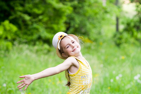 Happy little girl throwing-up hands