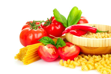 Pasta spaghetti with tomatoes, olive oil and basil on a white ba