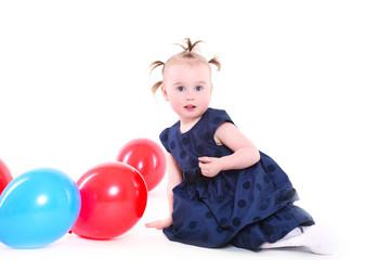 Fototapeta na wymiar little girl with plays with color balloons
