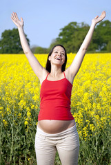Naklejka na ściany i meble Pregnant woman looking excited