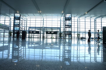travelers silhouettes at airport