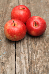 Red ripe apple on old wooden background