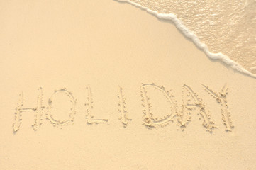 Hoilday Written in Sand on Beach