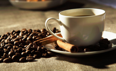 cup of coffee with tubes of cinnamon