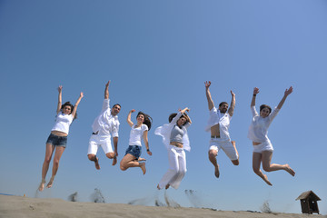 happy people group have fun and running on beach