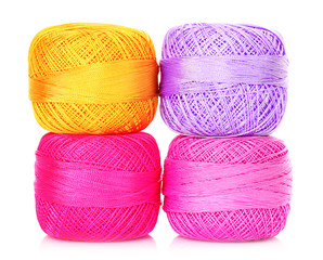 Few thread bobbins isolated on white