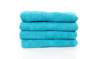 Pile of blue towels over white background