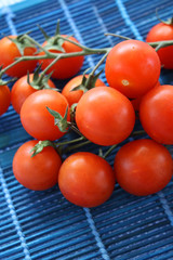 Cherry tomatoes on blue Wooden placemat