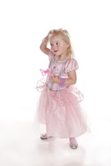 pretty little girl laughing in pink fairy princess dress
