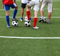 Soccer players with his foot on a football