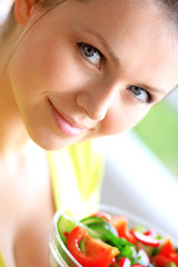 young beautiful woman holding salad