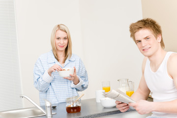 Breakfast happy couple eat cereal read newspaper