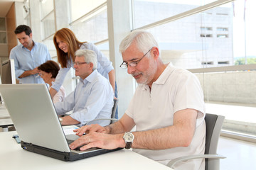 Senior man working on laptop computer