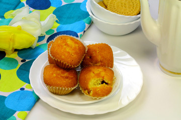 Some appetizing cakes, biscuits and tulip flowers
