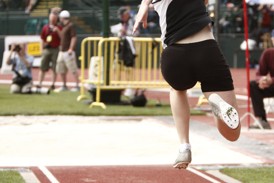 Female athlete competing on the "long jump" event