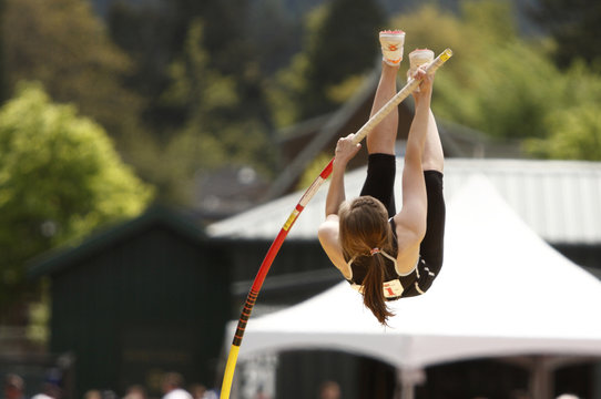 Female athlete competing in the pole vault