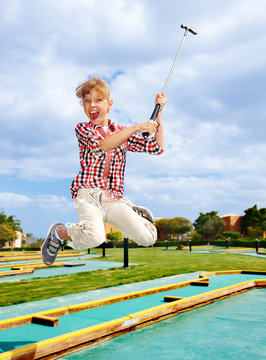 Little Girl Playing Golf In Park.