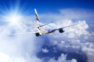 Airplane at fly on the sky with clouds