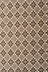 Rhomb pattern of brown fabric full frame.