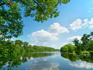 Summer river with bright blue sky