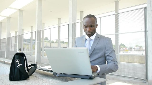 Businessman working with laptop computer outside the office