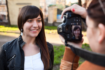 Woman photographer photographing the model in outdoors