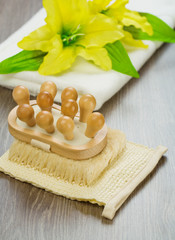 flower on towel and massager on bast