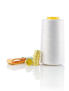 spool of thread with timbles and tapeline