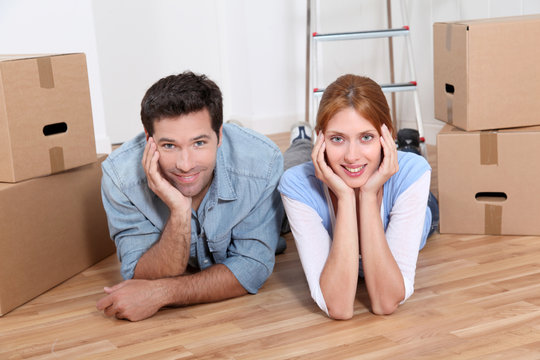 Couple laying on new house floor