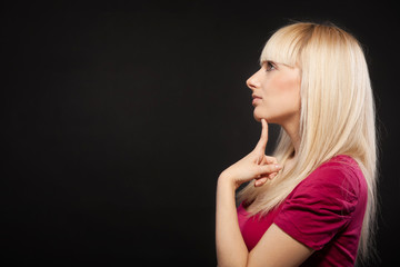 Sideview portrait of young beautiful female with long blond hair