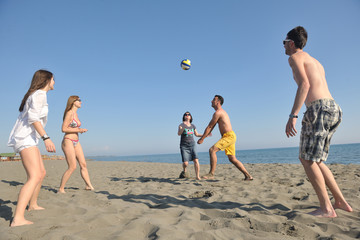 young people group have fun and play beach volleyball