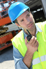 Foreman using walkie-talkie on construction site