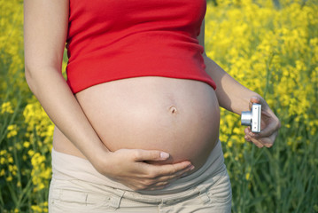 Pregnant woman taking picture of her belly